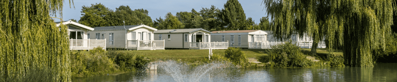 Park Management with EliteParks Holiday park with lodges by a lake, supported by EliteParks Park Management software.
